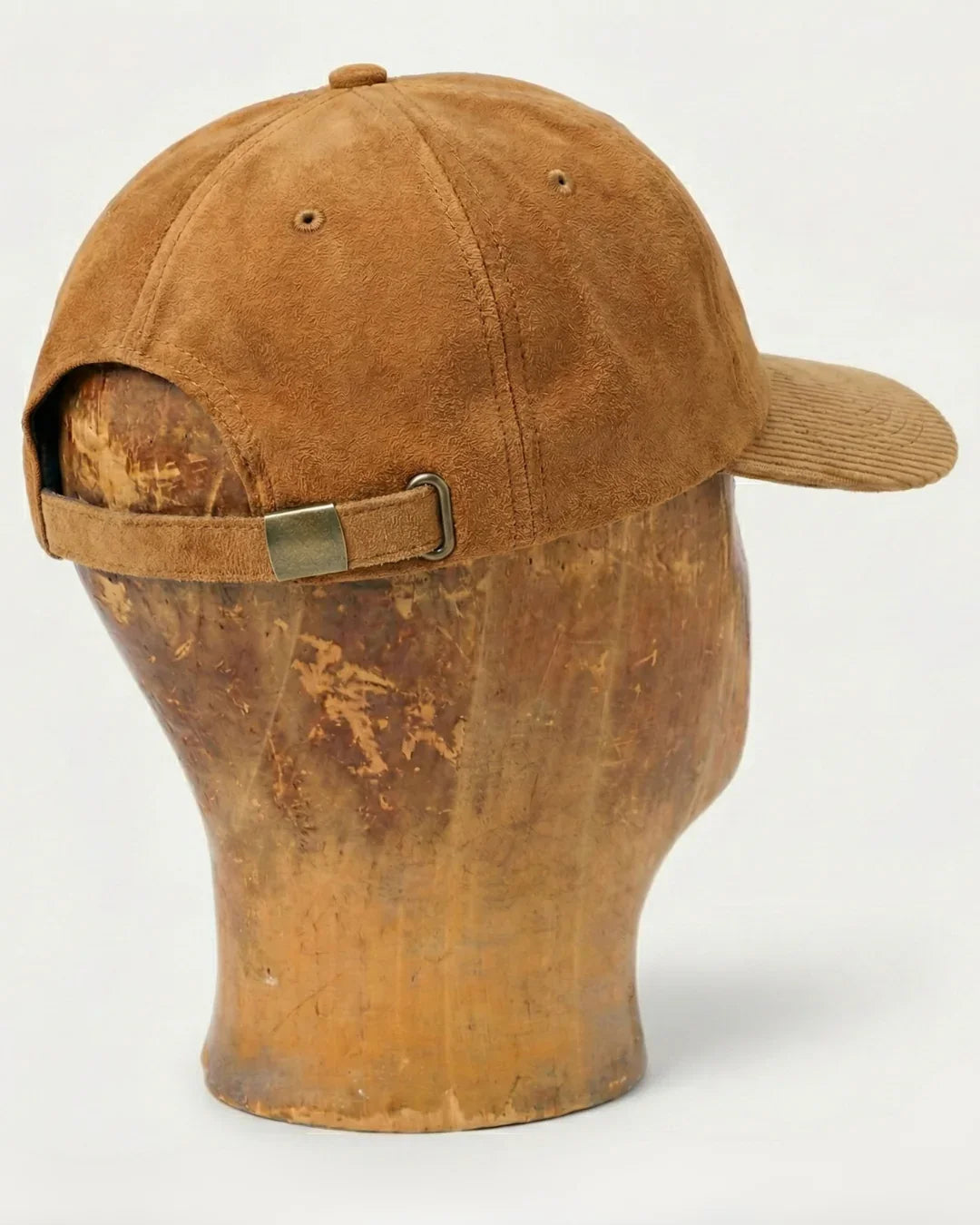 Brown suede baseball cap with adjustable strap, teeside accessory on display head