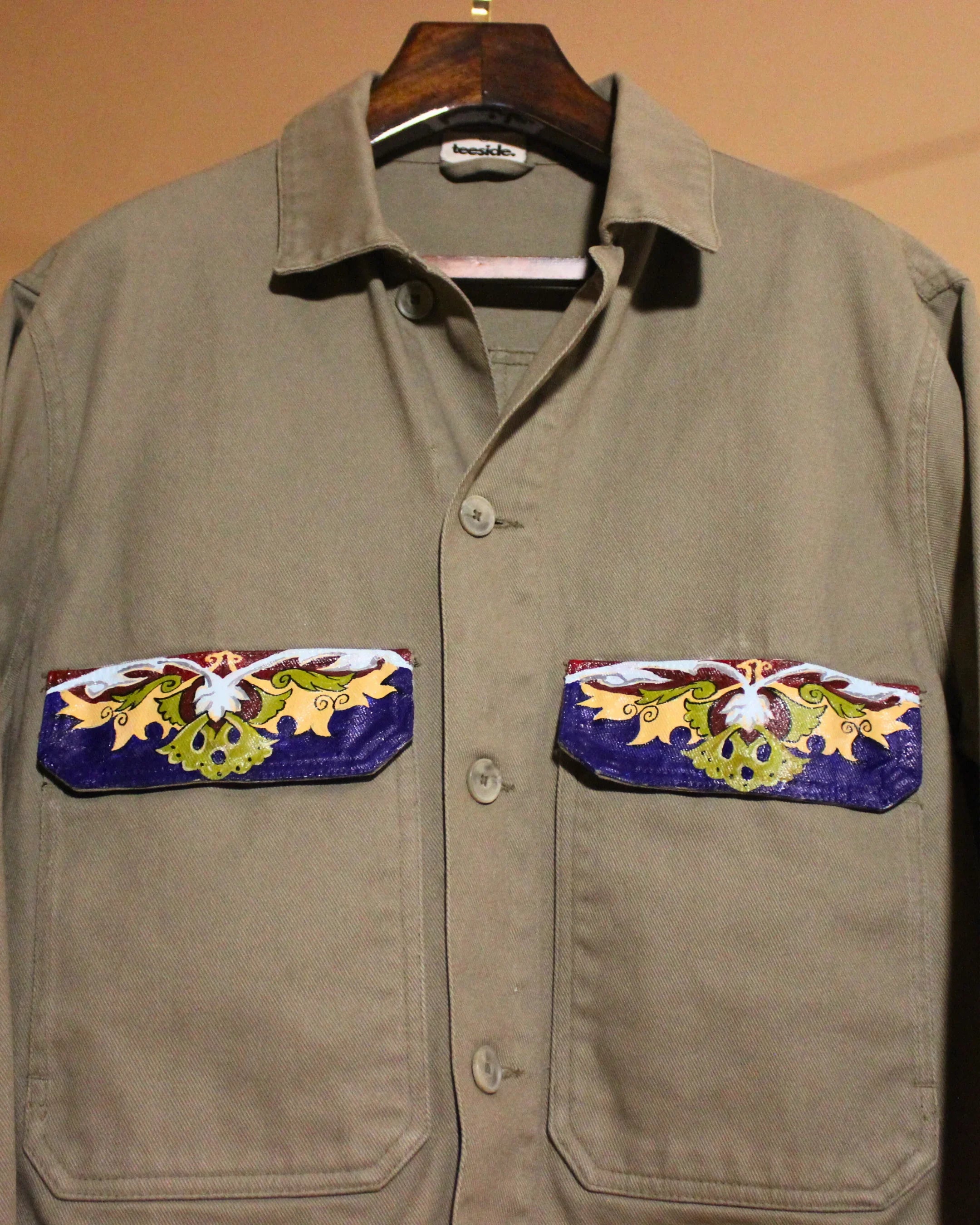 teeside khaki shirt with colorful embroidered floral pocket flaps on hanger