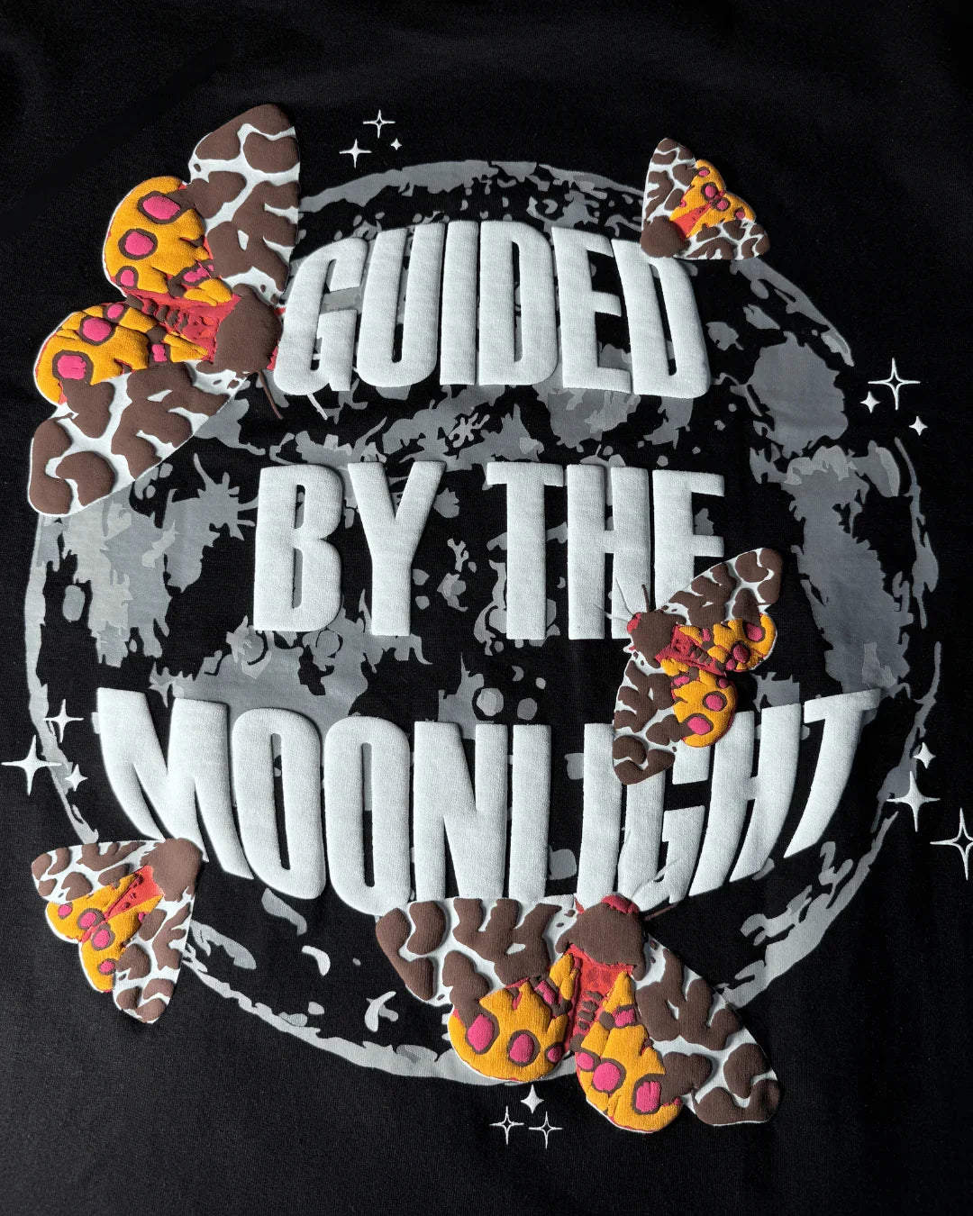 teeside black shirt with 'Guided by the Moonlight' text, colorful moths, and moon graphic
