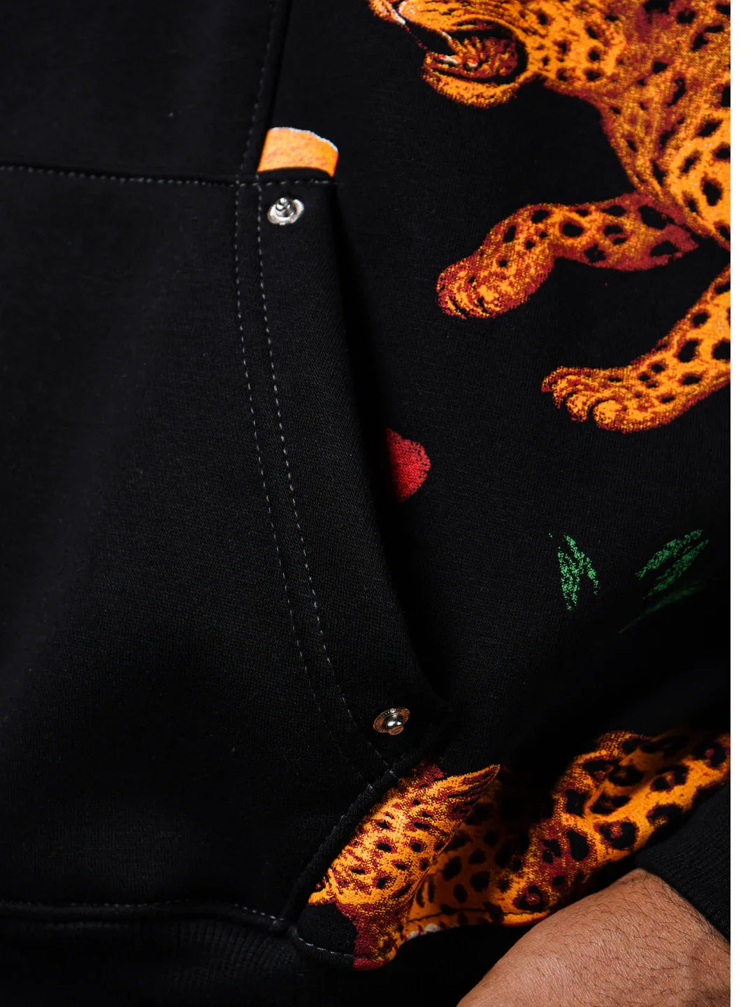 teeside black hoodie with vivid leopard and green leaf print close-up