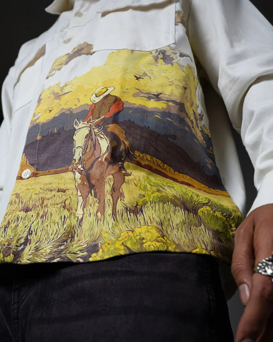 teeside shirt with cowboy and horse graphic on chest, western art design, closeup view