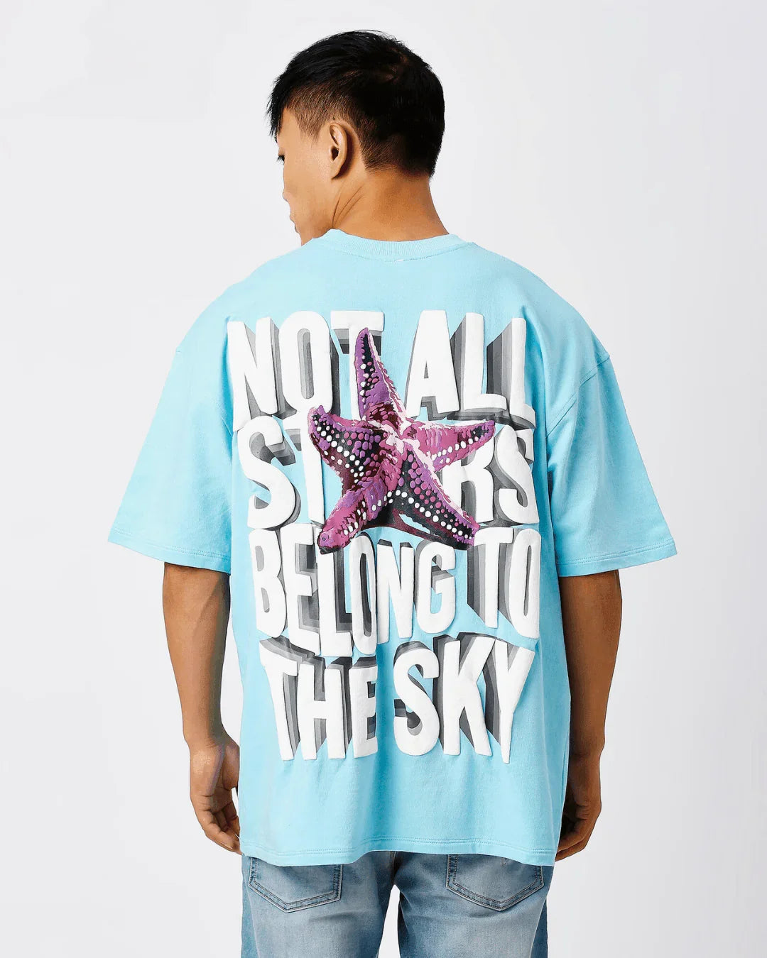 teeside blue t-shirt with bold 'Not All Stars Belong To The Sky' text and starfish graphic