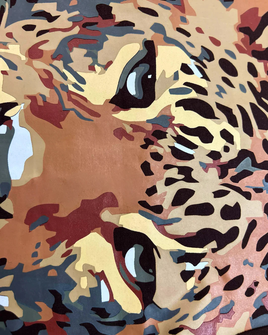 teeside abstract leopard face design with bold colors and artistic patterns