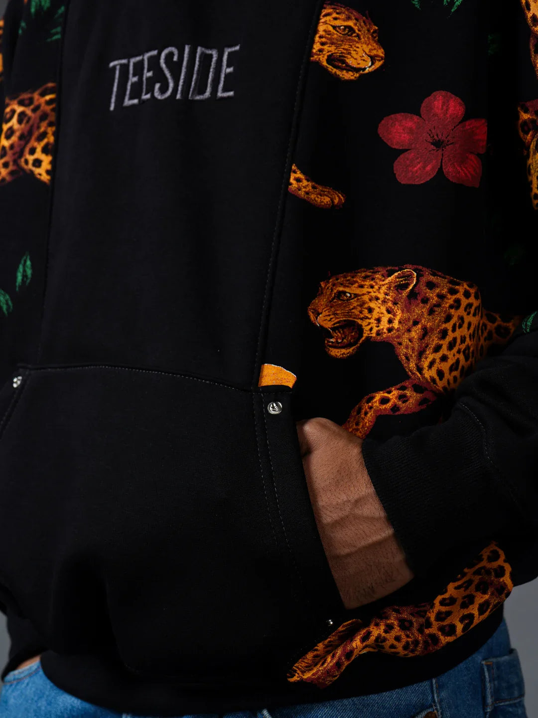 Teeside black hoodie with embroidered leopard, red flower, and front pocket detail